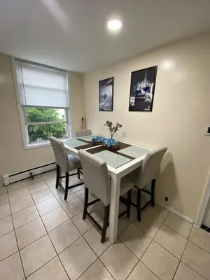 a dining room with a white table and chairs at Private room B in West NYNJ 12mints from NYCity Times Square in West New York