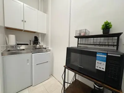 a kitchen with a microwave and a sink at The Midtown Ninth Manhattan Times Square in New York