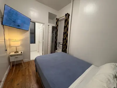 a small bedroom with a bed and a window at The Midtown Ninth Manhattan Times Square in New York
