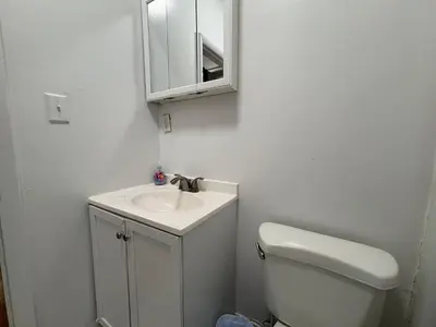 a bathroom with a toilet and a sink and a mirror at The Midtown Ninth Manhattan Times Square in New York