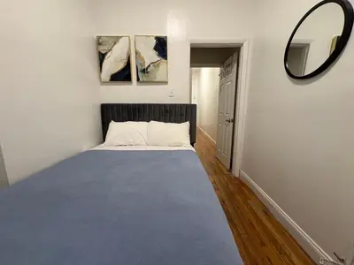 a bedroom with a large bed with a mirror on the wall at The Midtown Ninth Manhattan Times Square in New York