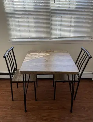 a wooden table and two chairs in front of a window at Private one-bedroom and one-bathroom apartment, private street entrance in convenient area, MetLife Stadium FIFA World Cup 35 minutes away in Perth Amboy