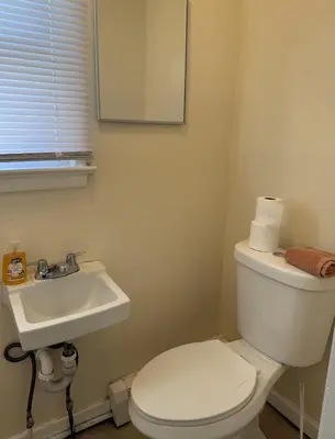 a bathroom with a white toilet and a sink at Private one-bedroom and one-bathroom apartment, private street entrance in convenient area, MetLife Stadium FIFA World Cup 35 minutes away in Perth Amboy