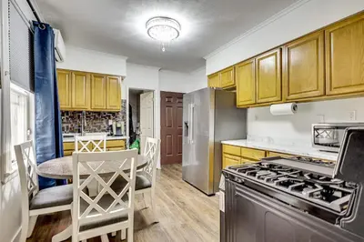 a kitchen with wooden cabinets and a stove top oven at Walk to Public Transit! Pet-Friendly Lodi Apt in Lodi