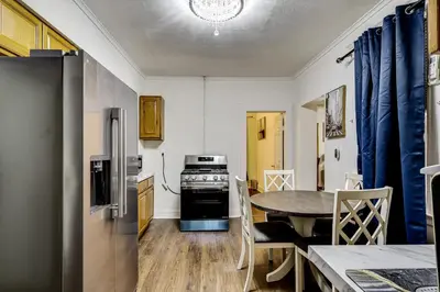 a kitchen with a table and a kitchen with a refrigerator at Walk to Public Transit! Pet-Friendly Lodi Apt in Lodi