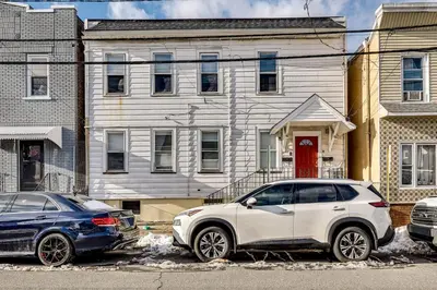 two cars parked in front of a house at Walk to Public Transit! Pet-Friendly Lodi Apt in Lodi