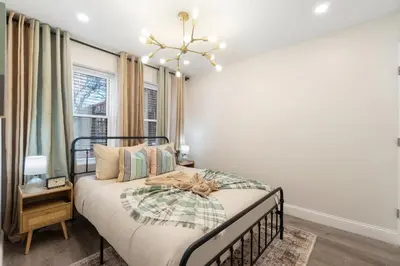 a bedroom with a bed and a window at Cozy 1BR level apartment w patio & workstation in Jersey City