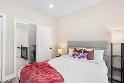 a bedroom with a large white bed with pillows at Holiday Home Brownstone City Stay 5BEDS, Private Dual Units in Jersey City