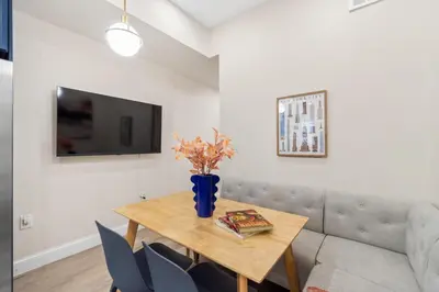 a dining room with a table and a couch at Holiday Home Brownstone City Stay 5BEDS, Private Dual Units in Jersey City