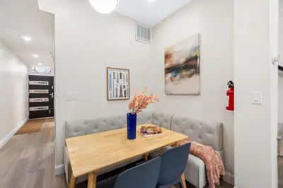 a dining room with a wooden table and chairs at Holiday Home Brownstone City Stay 5BEDS, Private Dual Units in Jersey City