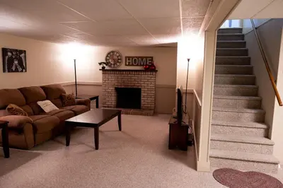 a living room with a couch and a fireplace at Cozy Home In The Middle Of Amish Country in Ronks