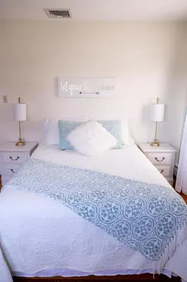 a bedroom with a white bed with a sign above it at Cozy Home In The Middle Of Amish Country in Ronks