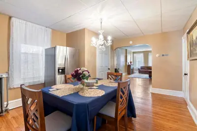 a dining room with a blue table and chairs at Moonbeam Suite-Private Room in Serenity Manor in Chester