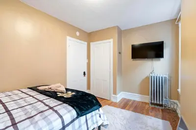 a bedroom with a bed and a flat screen tv at Moonbeam Suite-Private Room in Serenity Manor in Chester