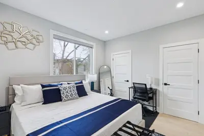 a bedroom with a large bed and a desk at Luxe Oasis with Gym - Near Stadium & Hospital with Rooftop in Philadelphia
