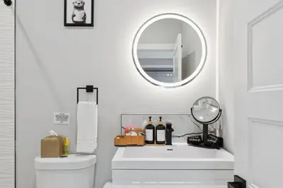 a white bathroom with a sink and a mirror at Luxe Oasis with Gym - Near Stadium & Hospital with Rooftop in Philadelphia