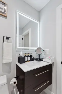 a bathroom with a sink and a mirror at Luxe Oasis with Gym - Near Stadium & Hospital with Rooftop in Philadelphia