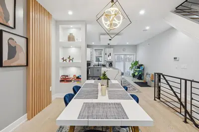 a dining room with a long table and blue chairs at Luxe Oasis with Gym - Near Stadium & Hospital with Rooftop in Philadelphia