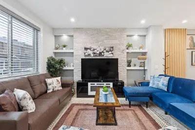 a living room with a couch and a tv at Luxe Oasis with Gym - Near Stadium & Hospital with Rooftop in Philadelphia