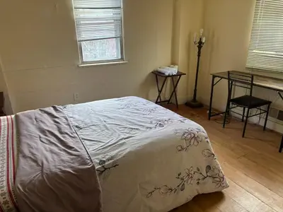 a bedroom with a bed and a table and a desk at 2131 Double Room F in Philadelphia
