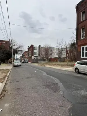 an empty street with cars parked on the side of the road at 2131 Double Room F in Philadelphia