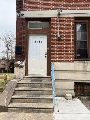 a white door on a brick building with stairs at 2131 Double Room F in Philadelphia