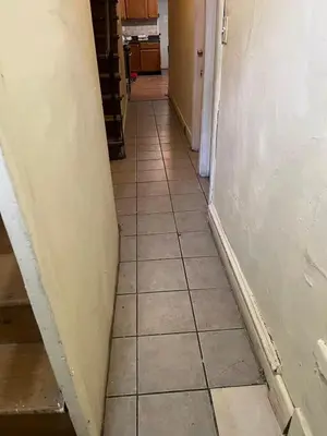 a hallway with a tile floor and a surfboard at 2131 Double Room F in Philadelphia