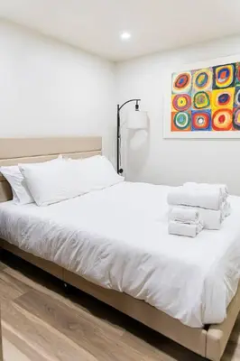 a bedroom with a white bed with towels on it at Cozy and Convenient Studio with 3 beds 10 Minutes to NYC in Union City
