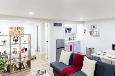a living room with a couch and a kitchen at Cozy and Convenient Studio with 3 beds 10 Minutes to NYC in Union City