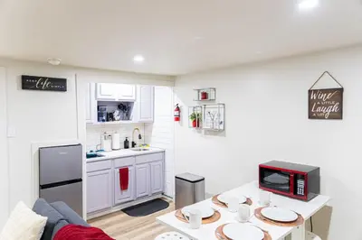 a kitchen and a living room with a table at Cozy and Convenient Studio with 3 beds 10 Minutes to NYC in Union City