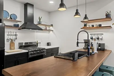 a kitchen with a wooden counter top and a sink at City Living without Compromise Full-Size 1BR in Philadelphia