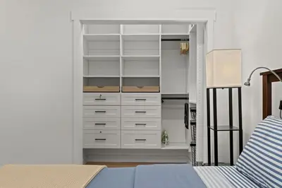 a bedroom with a closet with white drawers at City Living without Compromise Full-Size 1BR in Philadelphia