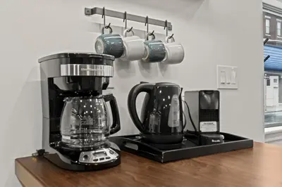 a kitchen counter with a blender and a coffee pot at City Living without Compromise Full-Size 1BR in Philadelphia