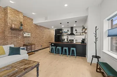 a living room with a couch and a kitchen at City Living without Compromise Full-Size 1BR in Philadelphia