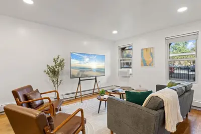 a living room with two couches and a flat screen tv at One Hamilton Essentials - 3 Bedroom 2 Bathroom Apt Mins to NYC in Jersey City
