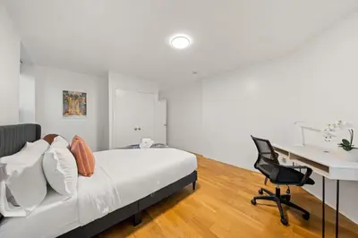 a bedroom with a bed and a desk and a chair at One Hamilton Essentials - 3 Bedroom 2 Bathroom Apt Mins to NYC in Jersey City