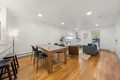 a dining room and living room with a table and chairs at One Hamilton Essentials - 3 Bedroom 2 Bathroom Apt Mins to NYC in Jersey City