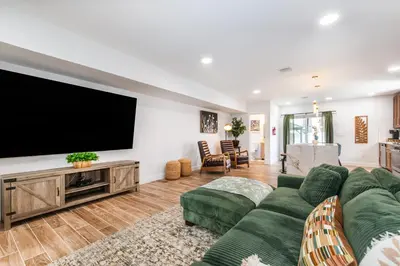 a living room with a large flat screen tv at Luxury Apartment in Irvington in Irvington