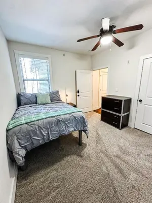 a bedroom with a bed and a ceiling fan at The Waverly in Newark