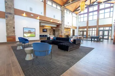 a large living room with a couch and chairs at The Waverly in Newark
