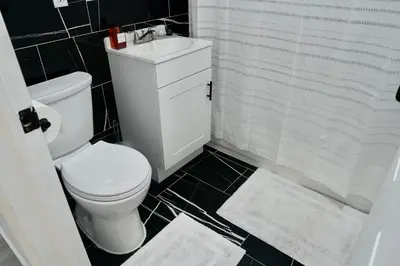 a bathroom with a toilet and a sink and a shower at Prime Oasis,1 mi to Temple U,Washer and Dryer,Free Snacks in Philadelphia