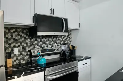 a kitchen with a stove and a microwave at Prime Oasis,1 mi to Temple U,Washer and Dryer,Free Snacks in Philadelphia