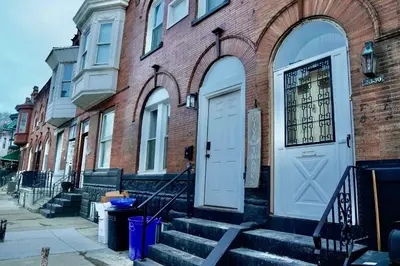 a brick building with a white door and stairs at Prime Oasis,1 mi to Temple U,Washer and Dryer,Free Snacks in Philadelphia