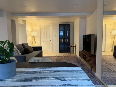 a living room with a couch and a tv at CASA 311 ! Welcome Home Private Parking Included in Jersey City