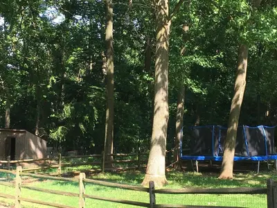 a group of tents in a park with trees at Lux Home 5 min to Train and Airport