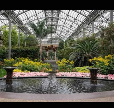 a large greenhouse with flowers and plants in it at Lux Home 5 min to Train and Airport
