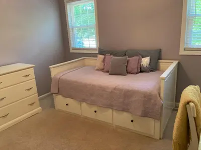 a bedroom with a bed with pillows on it at Lux Home 5 min to Train and Airport