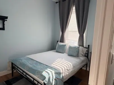 a small bed in a room with a window at Fresh&Quiet one bedroom Apartment in University City near Drexel&UPenn in Philadelphia