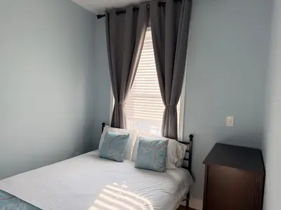a small bedroom with a bed and a window at Fresh&Quiet one bedroom Apartment in University City near Drexel&UPenn in Philadelphia