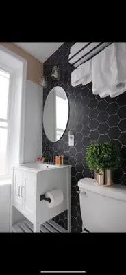 a bathroom with a sink and a mirror and a toilet at Fresh&Quiet one bedroom Apartment in University City near Drexel&UPenn in Philadelphia